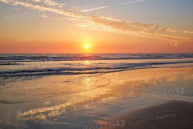 Atlantic ocean sunset with surging waves at Fonte da Telha beach