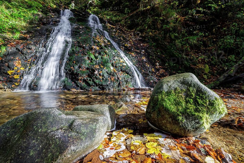 Mountain stream and waterfall in autumn forest
