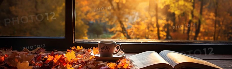 Cup and open book resting on window sill with a fall mountain country view banner