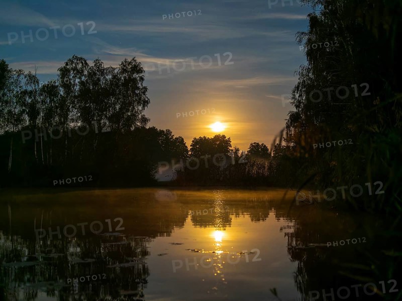 Full moon setting at the lake