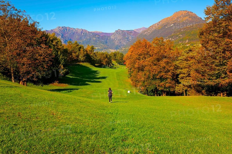 Golfer on Hole 1 in Golf Course Menaggio with Mountain View in Autumn in Lombardy