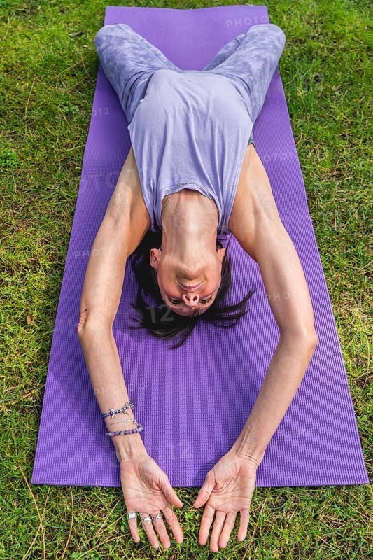 Hihg angle view of a woman lying on a yoga block to improving posture