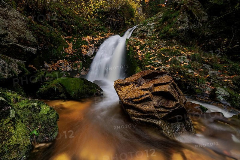 Mountain stream with waterfalls in autumn
