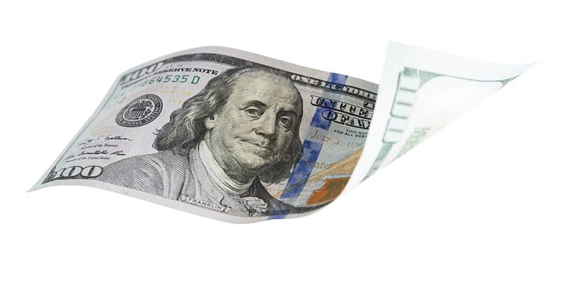 One hundred dollar bill falling or floating on empty background