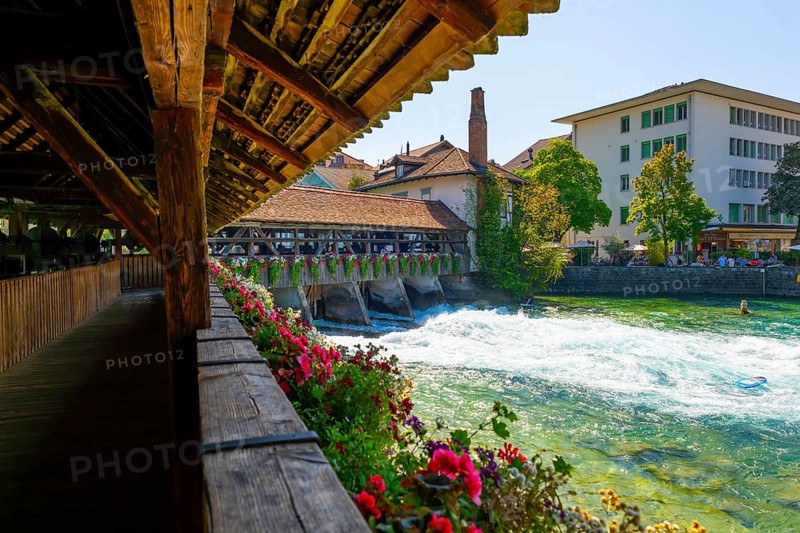 River Aare in City of Thun and Untere Schleuse Wooden Bridge in a Sunny Summer Day in Thun