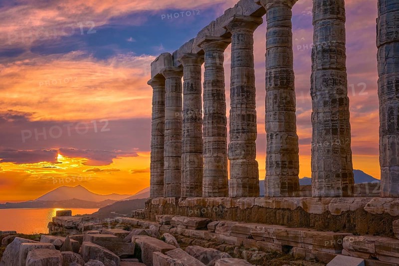 Beautiful sunset sky and ancient ruins of temple of Poseidon