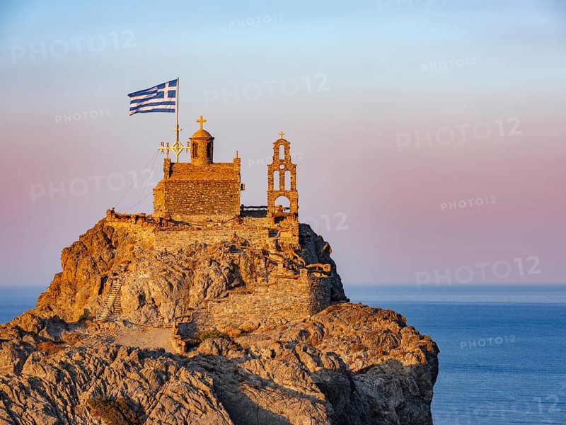 Chapel of St. Paisios perched on rocks at sunrise