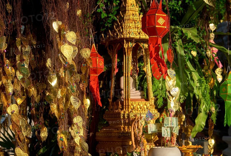Traditional Thai Buddha altar as busabok with money and incense sticks offerings