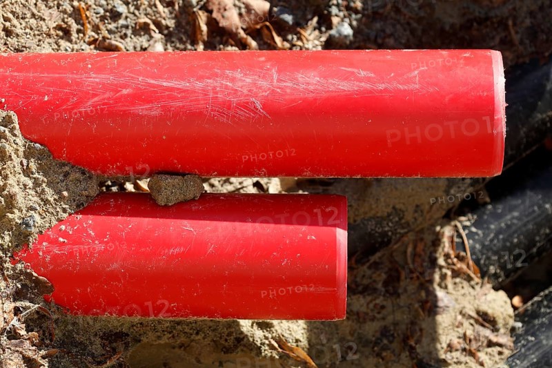 Red pipes in the sand on a construction site