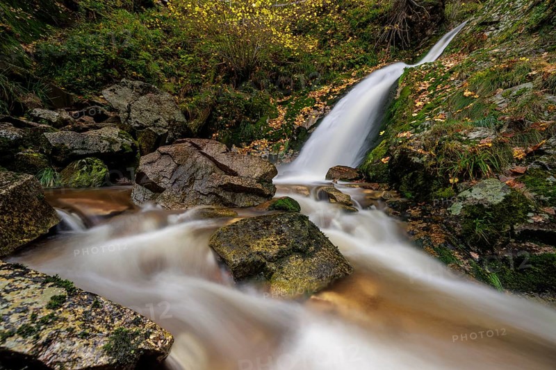 Mountain stream with waterfalls in autumn