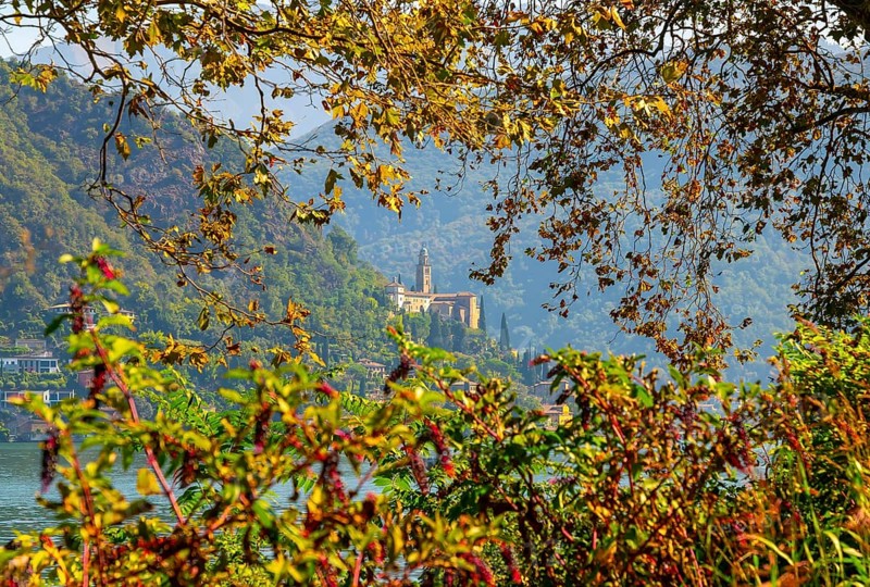 Church Santa Maria del Sasso with Trees Branches on the Mountain Side and Lake Lugano in Morcote
