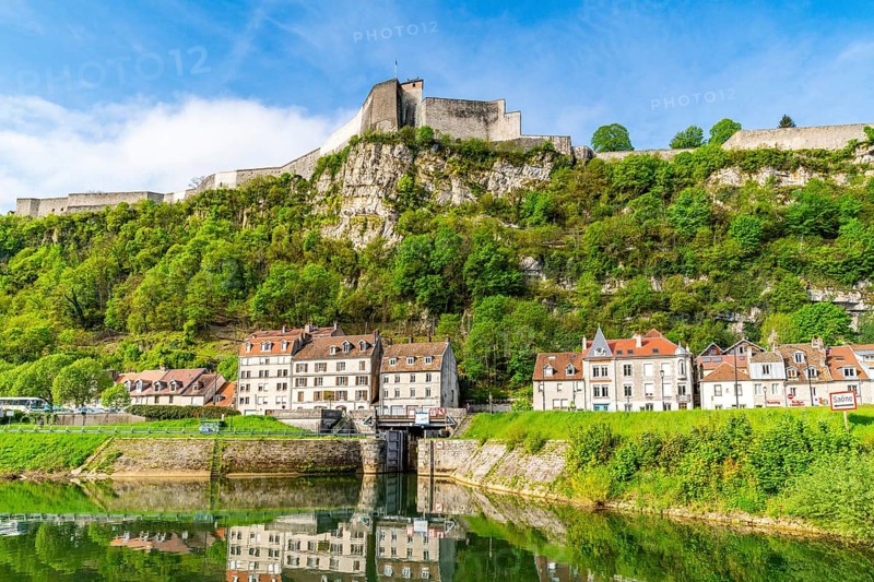 Houses at the foot of Mount Saint Etienne with the World Heritage Site of the Citadel of Besancon on the Doubs River