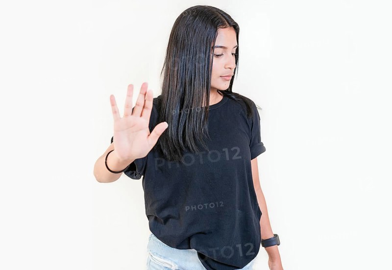 Young girl gesturing stop with palm of hand isolated. Teenage girl rejecting with the palm of her hand. Latin people gesturing stop isolated
