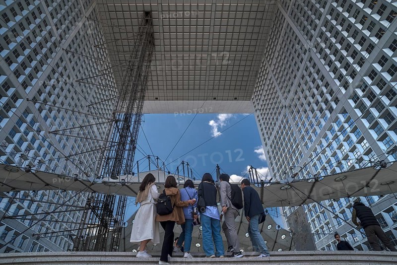 Tourists take a souvenir photo in the Grand Arche