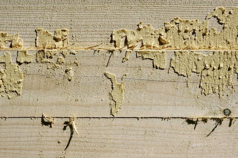 Wooden beams with remains of sawdust in a sawmill