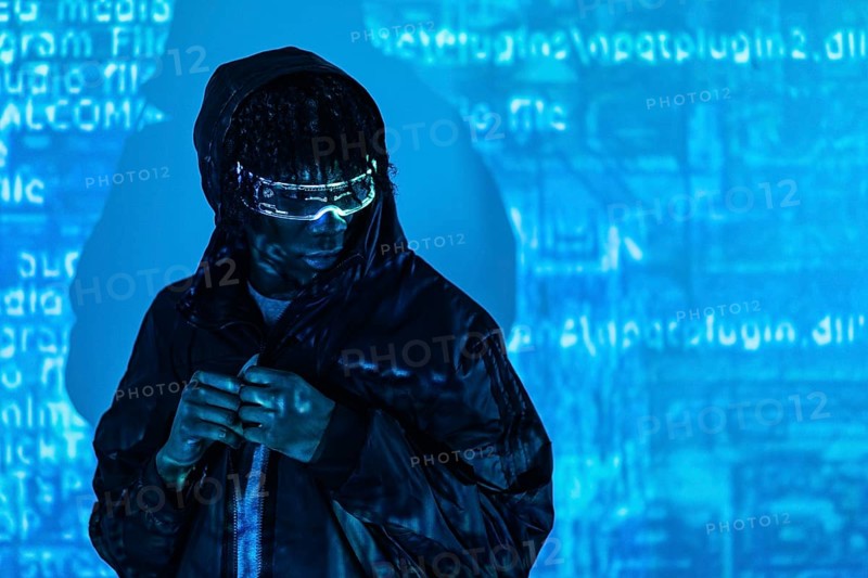 Portrait with blue neon lights of a futuristic man with augmented reality glasses