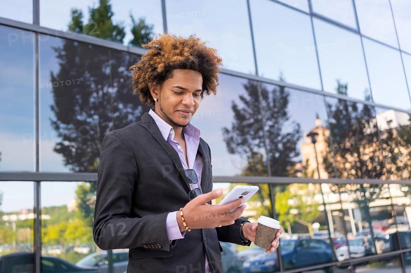 Portrait with copy space of an african american businessman using mobile on a coffee break