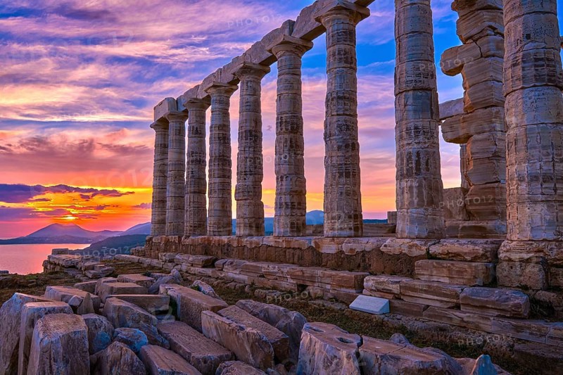 Beautiful sunset sky and ancient ruins of temple of Poseidon