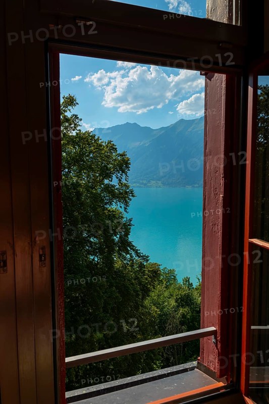 Window View from The Historical Grandhotel Giessbach with View over Mountain and Lake Brienz with Sunlight in Giessbach