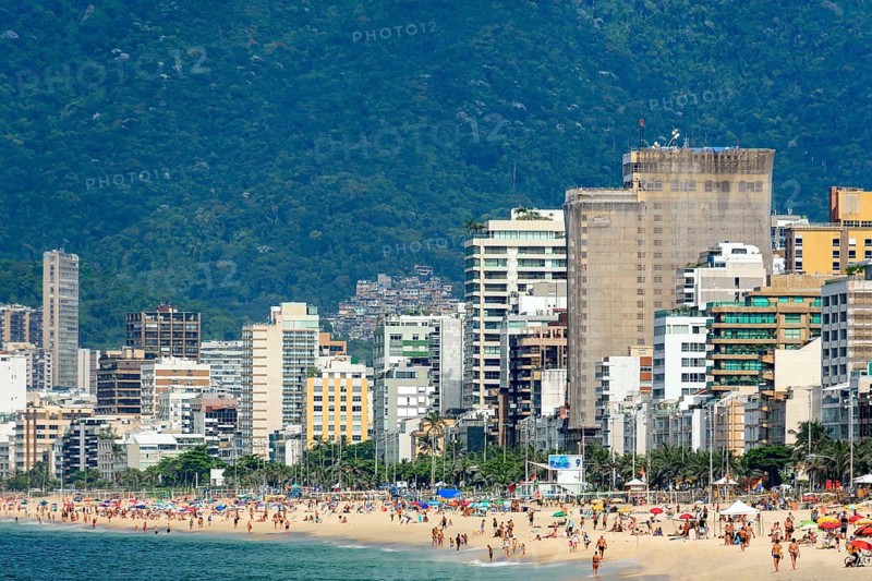 Summer day in the city of Rio de Janeiro with Ipanema beach occupied by city residents and tourists