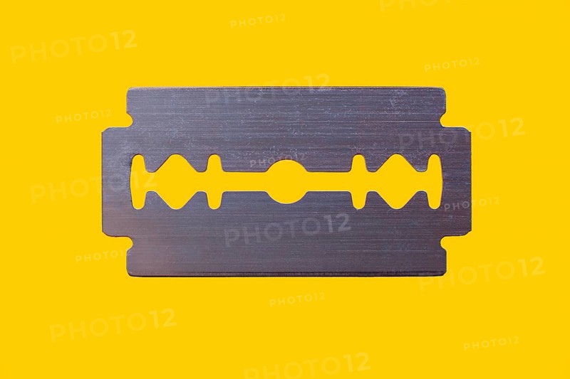 Razor blade against yellow background
