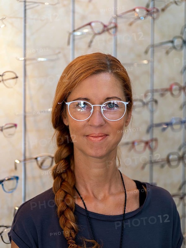Woman at optician tries on new glasses