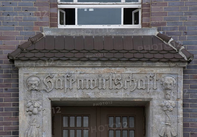 Lettering on a heritage-protected building commemorates its former use as a port economy
