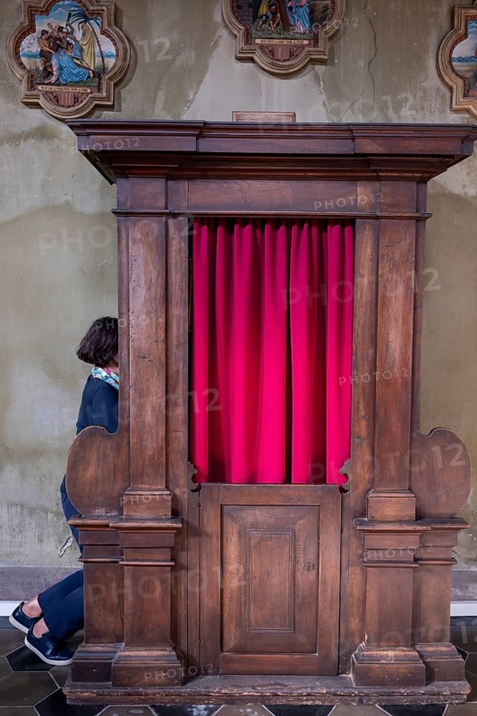 Woman Confesses Inside a Beautiful Church of San Carpoforo with Sunlight in Bissone