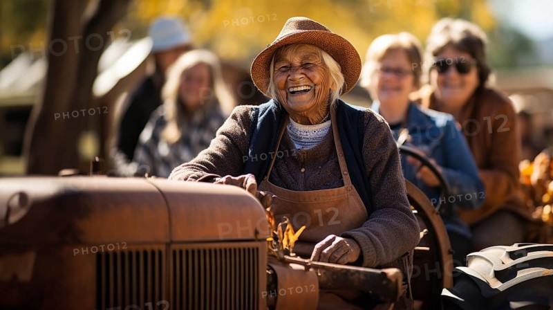 Happy female farmer giving a few guests a tractor ride one fall day