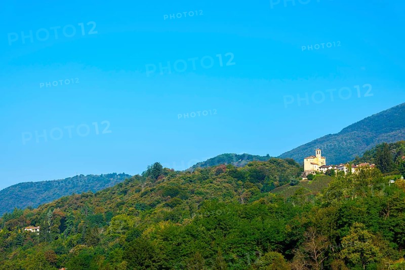 Church in Castelrotto and Village on Mountain Range and Valley with Sky in a Sunny Summer Day in Malcantone