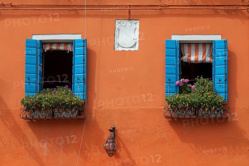 Orange house facade with two windows