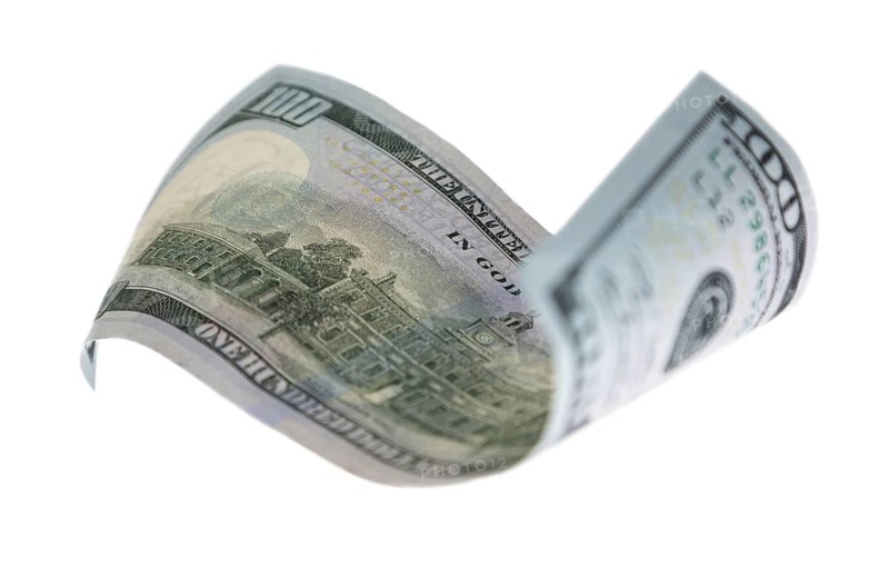 One hundred dollar bill falling or floating on empty background
