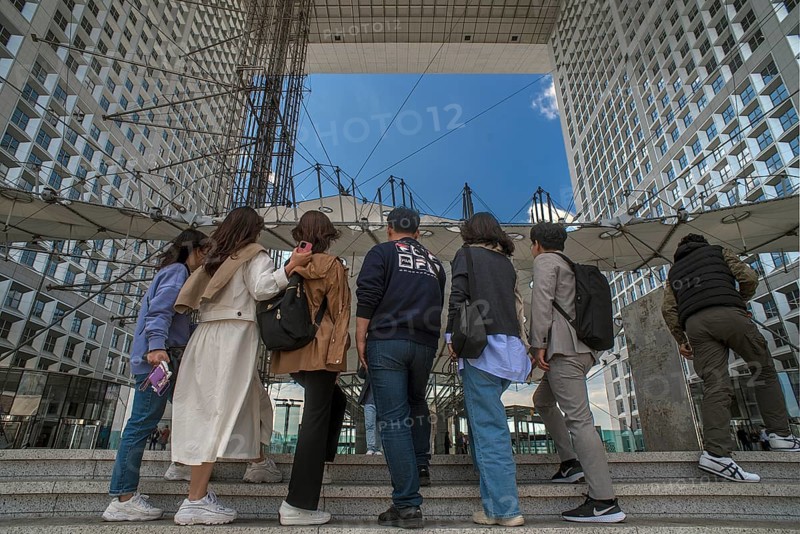 Tourists take a souvenir photo in the Grand Arche