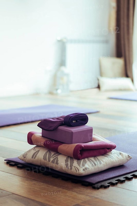 Empty yoga studio interior with mats and accessories. Copy space. Vertical shot