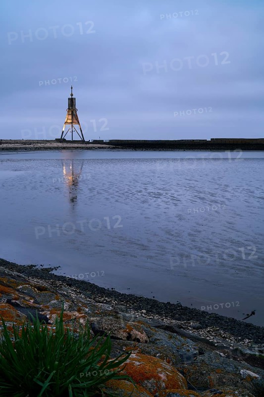 Kugelbake illuminated with water reflection at dusk