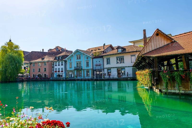 River Aare in City of Thun and Untere Schleuse Wooden Bridge in a Sunny Summer Day in Thun