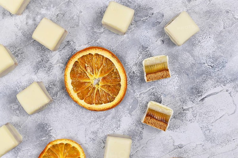 German Christmas candy called 'Dominosteine' and orange slices. A traditional food consisting of gingerbread