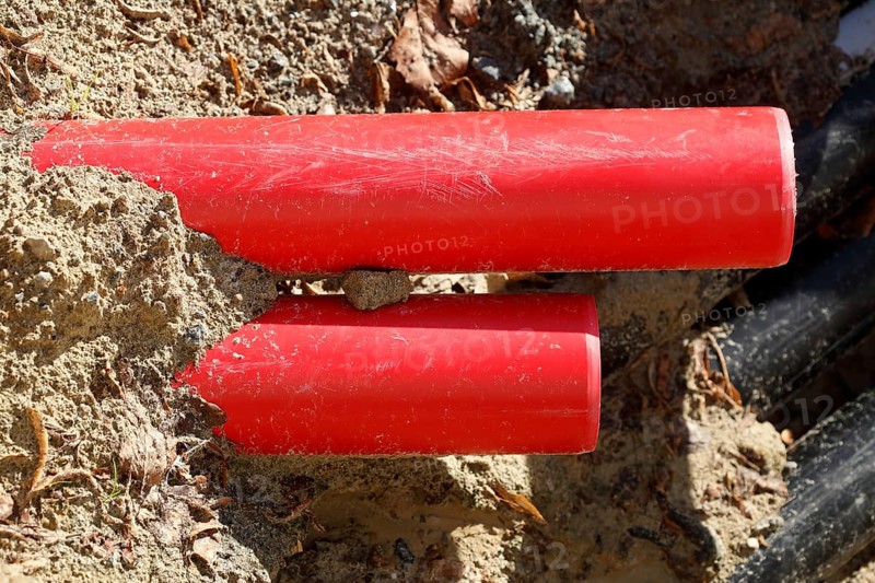 Red pipes in the sand on a construction site