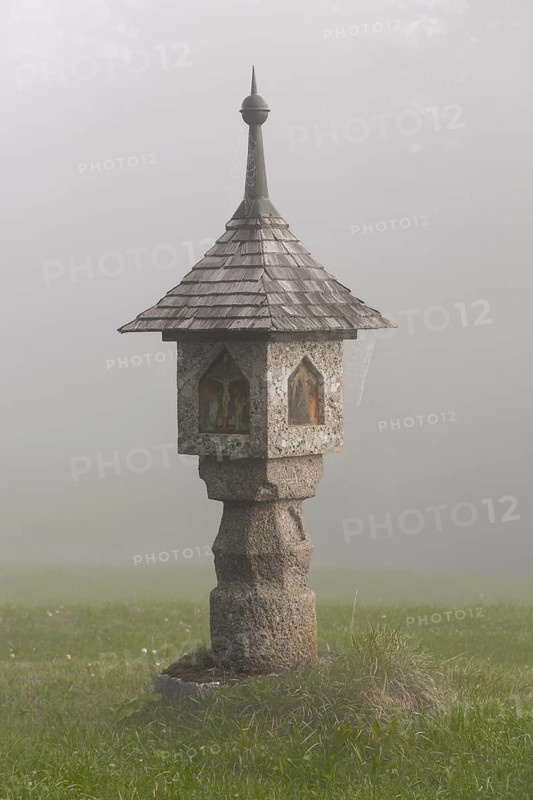 Wayside shrine in the autumnal fog