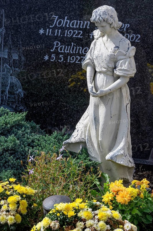 Gravestone with mourning female figure and floral decoration
