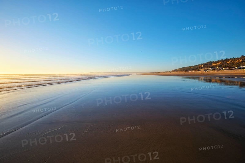 Atlantic ocean sunset with surging waves at Fonte da Telha beach
