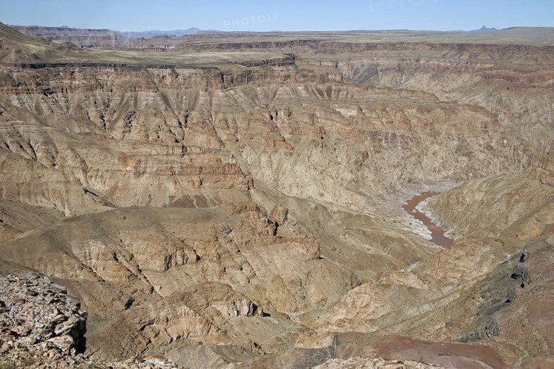 Water of stream flowing through the eroded rocks of the Fish River Canyon