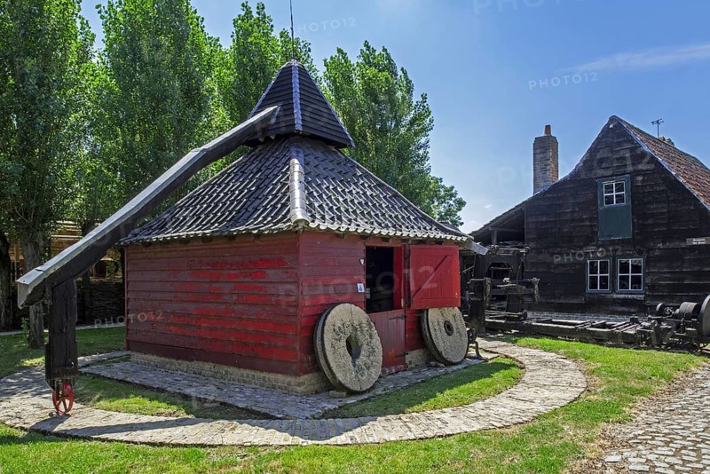 Old Flemish wooden horse mill which uses animal power for grinding grain at the open air museum Bachten de Kupe