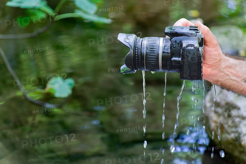 A reflex camera accidentally falls into the river