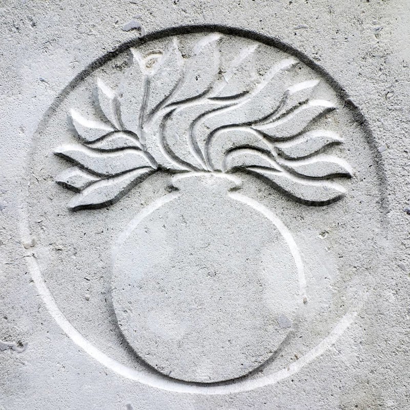 Grenadier guards regimental badge on headstone at Cemetery of the Commonwealth War Graves Commission for First World War One British soldiers