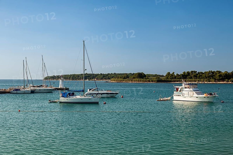 Sailboats anchor in the harbor entrance of Novigrad
