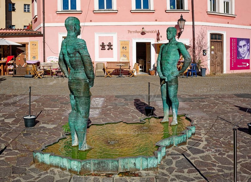 Two male figures peeing