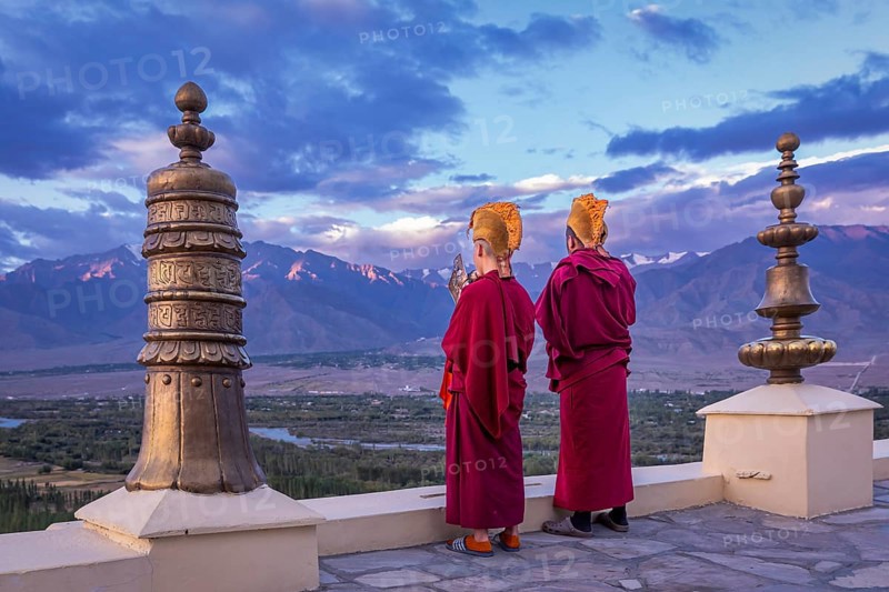 Monks blowing conches at Spituk Monastery
