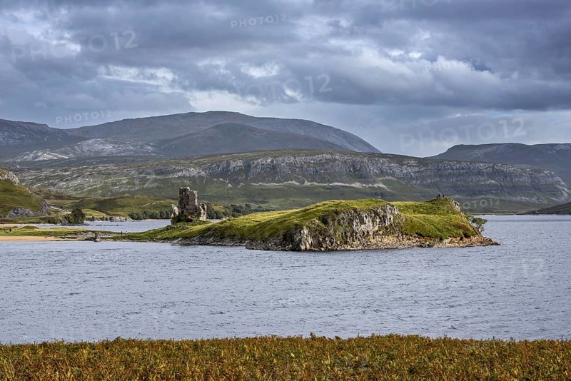 16th century Ardvreck Castle ruins at Loch Assynt in the Highlands at sunset