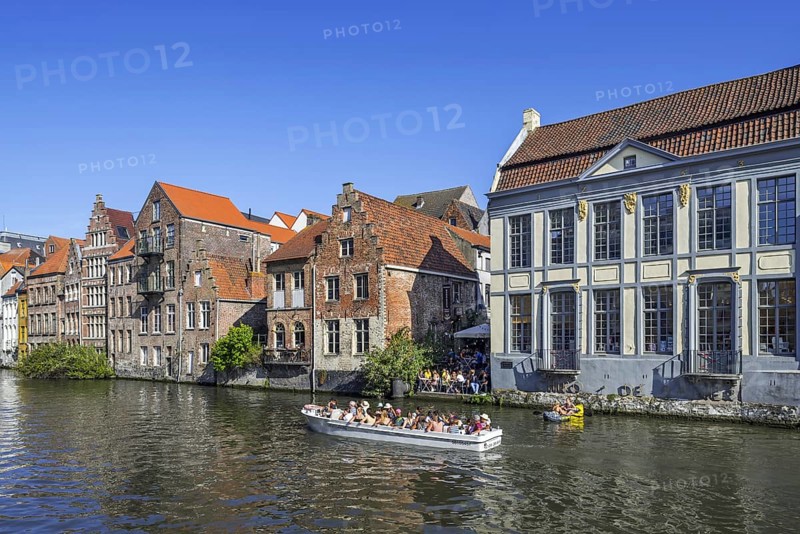 Sightseeing boat with tourists navigating on the river Leie
